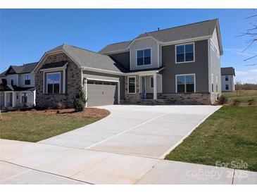 Beautiful two-story home with a stone facade, attached garage, and a long driveway at 2084 Fordhill St, Rock Hill, SC 29732