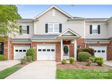 Charming townhome with brick accents, well-manicured landscaping, and a single-car garage at 3906 Thomas Ridge Dr, Charlotte, NC 28269