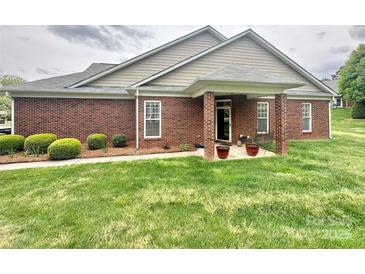 Charming brick home featuring a cozy front porch and well-maintained landscaping at 4223 Willow View Ct, Matthews, NC 28105