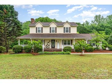 Inviting two-story home with a covered porch, lush landscaping, and a well-maintained lawn at 6769 Highway 557 None, Clover, SC 29710