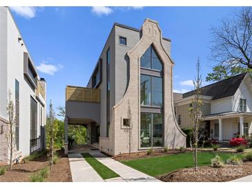 Stunning modern home with architectural detail, three-story window feature, and inviting driveway at 721 Charles Ave, Charlotte, NC 28205