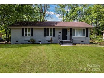 Charming one-story home with a well-manicured lawn and freshly painted exterior at 801 Bilmark Ave, Charlotte, NC 28213