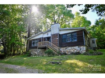 Charming home featuring a stone foundation and wooden siding, nestled in a lush, green environment at 1042 Jackson Rd, Fort Lawn, SC 29714