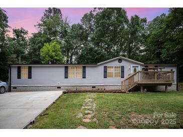 Charming home featuring an inviting entryway, well-maintained lawn, and a welcoming front deck at 114 Oakland Rd, Belmont, NC 28012