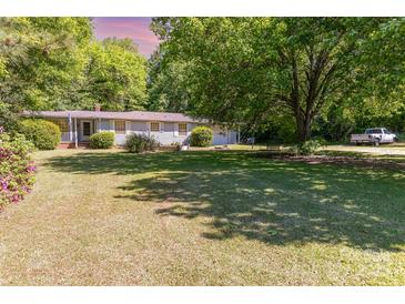Charming single-story home with a well-maintained front yard and mature shade trees at 3332 Celanese Rd, Rock Hill, SC 29732