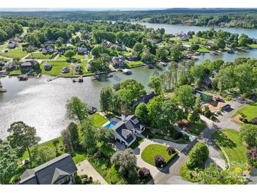 Stunning aerial view of a lakefront home with a pool, lush landscaping, and private dock at 4039 5Th Nw St, Hickory, NC 28601