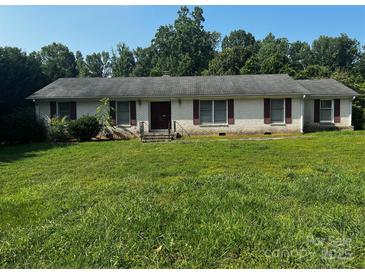 Charming single-story brick home with red shutters and a large front lawn at 629 Belmorrow Dr, Charlotte, NC 28214