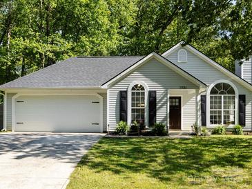Charming single-story home with a well-maintained lawn, attached garage, and inviting curb appeal at 7731 Ivy Hollow Dr, Charlotte, NC 28227
