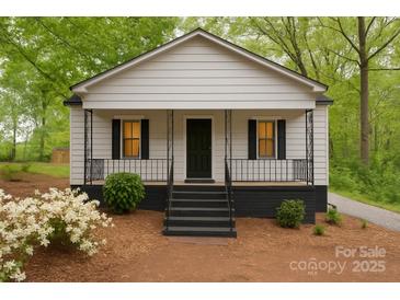 Charming home with a cozy front porch, black shutters, and a well-manicured yard at 905 Gantt St, Kings Mountain, NC 28086