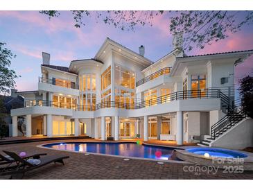 Stunning outdoor pool area with spa, lounge chairs, and multi-level balconies on a modern luxury home at 102 Eastham Ct, Mooresville, NC 28117