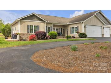 Charming home featuring manicured lawn, beautiful landscaping, and inviting front porch at 15 Willow Oaks Ct, Taylorsville, NC 28681