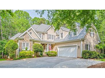 Charming two-story home with stone accents, well-manicured landscaping, and attached two car garage at 19729 Callaway Hills Ln, Davidson, NC 28036