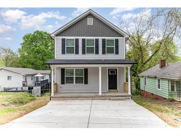 Charming two-story home featuring a covered front porch, gray siding and black shutters, offering classic curb appeal at 213 Rosemont Ave, Kannapolis, NC 28081