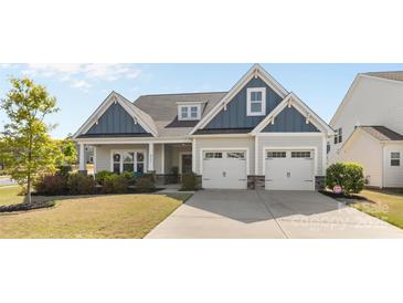Charming two-story home featuring blue and gray siding, a two-car garage, and a well-manicured front yard at 2704 Watergarden St, York, SC 29745