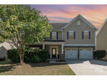 Charming two-story home featuring a stone-accented facade, well-manicured lawn, and a two-car garage at 3912 Franklin Meadows Dr, Matthews, NC 28105