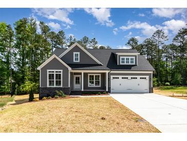 Charming gray two-story home with a two-car garage and a well-manicured front lawn at 5162 Beckenham Ln, Concord, NC 28025