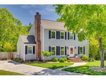 Charming two-story home with a brick chimney, well-maintained lawn, and inviting landscaping at 7300 Chatterbird Ct, Charlotte, NC 28226