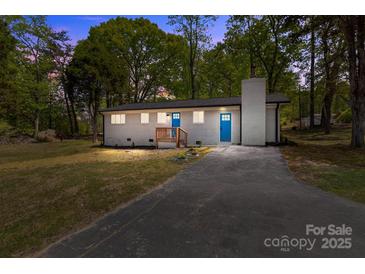 Charming single-story home with a brick chimney and a well-maintained lawn at 880 Legion Club Rd, Salisbury, NC 28146