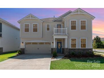 Inviting two-story home with a well-manicured lawn and a charming covered front porch at 9102 Buckley Ct, Charlotte, NC 28269