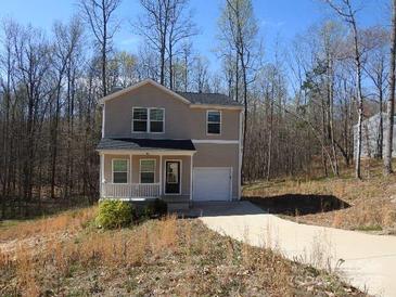 Charming two-story home featuring a covered porch, neutral siding, and attached one car garage with extended driveway at 108 Harvest Moon Ct, Statesville, NC 28625