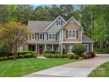 Inviting two-story home featuring manicured landscaping and a welcoming front porch at 116 Anderson Farm Ct, Mooresville, NC 28117