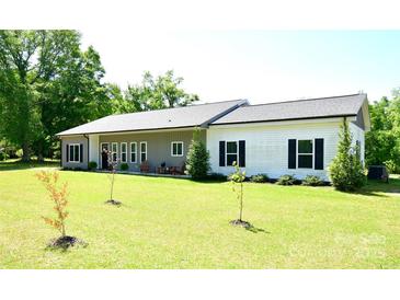 Charming single-story home with a well-manicured lawn and inviting front porch at 129 Devon Dr, Heath Springs, SC 29058
