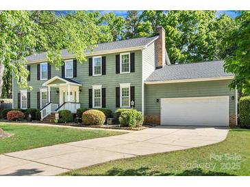 Charming two-story home with a well-maintained lawn, a two-car garage, and a traditional design at 16614 Beech Hill Dr, Huntersville, NC 28078