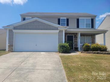Charming two-story home featuring a two-car garage, covered porch, and well-maintained front yard at 1849 Meadow Crossing Dr # 118, Huntersville, NC 28078