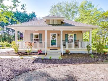 Charming single-story home with inviting front porch, manicured landscaping, and neutral exterior paint at 215 6Th St, Belmont, NC 28012