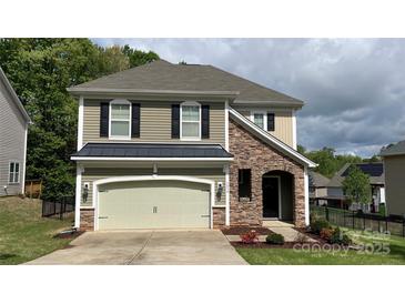 Charming home featuring stone accents, neutral siding, a two-car garage, and well-maintained landscaping at 3030 Collin House Dr, Fort Mill, SC 29715
