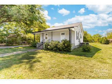 Charming single story home featuring a cozy front porch and manicured lawn at 3117 Fraley Church Rd, Gastonia, NC 28054