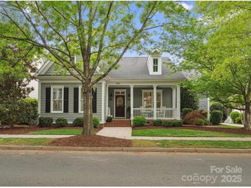 Charming single-story home with a covered porch, complemented by mature trees and manicured landscaping at 894 Stratford Run Dr, Fort Mill, SC 29708