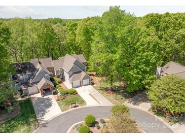 Gorgeous aerial view of homes with manicured lawns, attached garages and lush, mature trees surrounding the property at 9012 Saint Thomas Ln, Charlotte, NC 28277