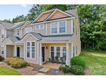 Charming two-story townhome featuring a welcoming front porch and well-manicured lawn at 1161 Constitution Park Blvd, Rock Hill, SC 29732