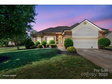 Charming single-story brick home with well-manicured lawn and inviting front entrance, illuminated by twilight sky at 123 Shoreview Dr, Mooresville, NC 28117