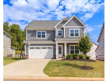 Charming two-story home with gray siding, a well-manicured lawn, and a two-car garage at 1358 Cedardale Ln, Denver, NC 28037