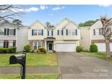 Charming two-story home with stone accents, blue shutters, well-manicured lawn and two car garage at 16219 Long Talon Way, Charlotte, NC 28273