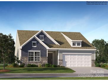 Charming two-story home boasts a mix of stone and siding, an attached two-car garage, and meticulously landscaped front yard at 1627 Spring Lot Dr, Edgemoor, SC 29712