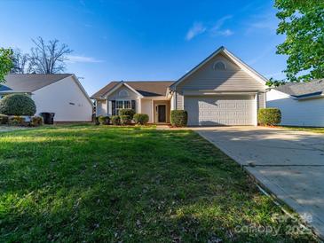 Charming single-story home with a well-manicured lawn and attached two-car garage at 1762 Tate Rd, Rock Hill, SC 29732