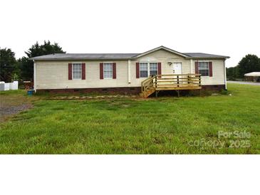 Charming single-story home featuring a quaint front porch and well-maintained lawn at 234 Olin Loop, Olin, NC 28660