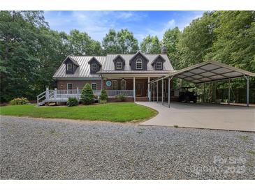 Charming brick home with a metal roof, covered porch, and convenient carport on a well-maintained lot at 32060A Flint Ridge Rd, Albemarle, NC 28001