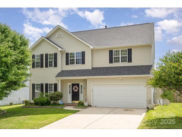 Two-story home with black shutters, fresh green lawn and a two car garage under a cloudy blue sky at 407 Goodloe Dr, Charlotte, NC 28262