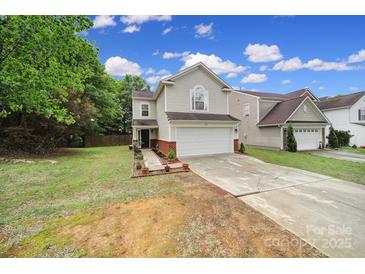 Charming home with a two-car garage, lush lawn, brick accents, and inviting curb appeal at 5524 Wyalong Dr, Charlotte, NC 28227