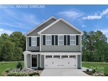 Charming two-story home with gray siding, white trim, and an attached two-car garage at 1813 Millstream Dr, China Grove, NC 28023