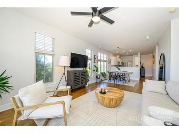 Bright living room featuring hardwood floors, an area rug, and natural light streaming through the windows at 1101 W 1St St # 405, Charlotte, NC 28202