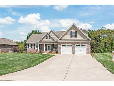 Beautiful brick home with a manicured lawn and a long driveway at 115 Ladybug Ct, Statesville, NC 28625