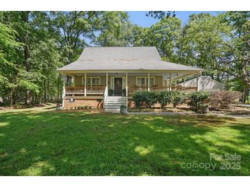 Charming single-Gathering home with a covered front porch and lush green lawn surrounded by mature trees at 13916 & 13912 Sledge Rd, Charlotte, NC 28278