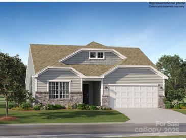 Charming single-story home showcasing a stone-accented facade, light gray siding, and a spacious two-car garage at 1613 Spring Lot Dr, Edgemoor, SC 29712
