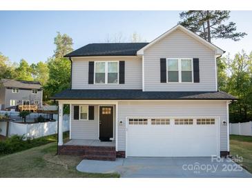 Charming two-story home featuring a two-car garage, covered front porch, and well-maintained landscaping at 206 N Kayla Dr, Salisbury, NC 28146