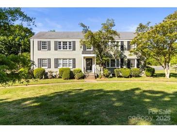 Charming traditional home featuring a well-manicured lawn and mature trees at 241 Wakefield Dr # C, Charlotte, NC 28209